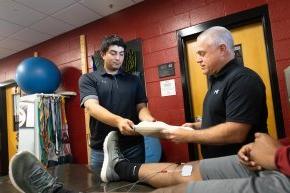 Michael Flicker and Andy Lopez stand inside a room