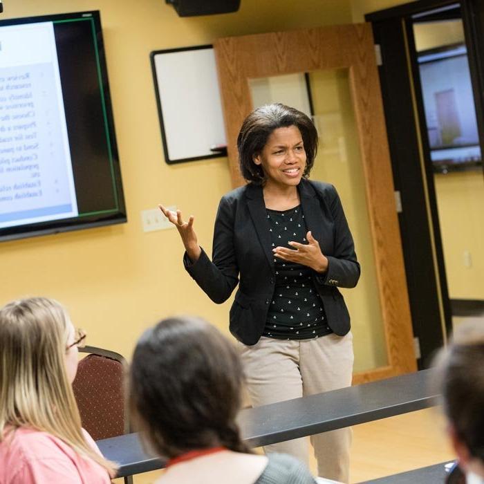 Professor delivers lecture in front of class